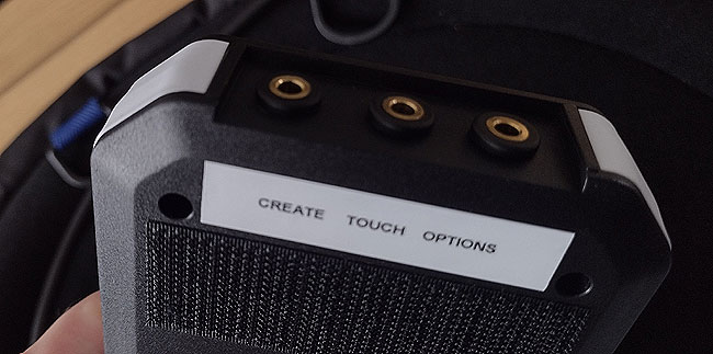 Create, Touch-click and Options switch interface from underside, viewing the label and Velcro.