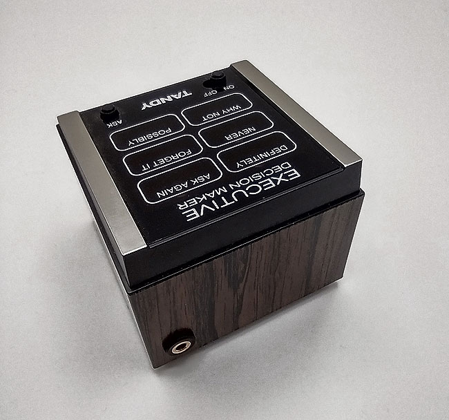 Rear view of Executive Decision Maker with added accessibility switch socket. Wood veneer and brushed silver.