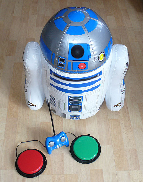 R2-D2 inflatable robot with blue remote control and two accessibility switches.