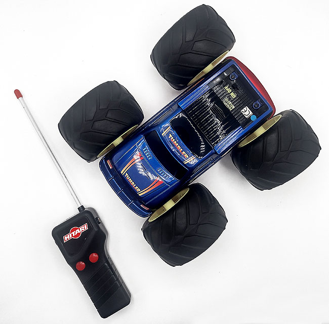 OneSwitch adapted Hitari Tumbler remote control car with remote overhead view.