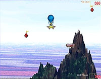 An air balloon near a craggy mountain against a whispy sky.
