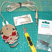 Image of skull tattoo switch, knife, 3.5mm plug and SUGRU 5g pouch.