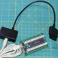 Image of an Ultimarc iPac  Circuit Board with PS/2 to PS/2 lead and Playstation 2 Adapter.