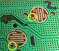 Front of PCB with two small drilled holes.